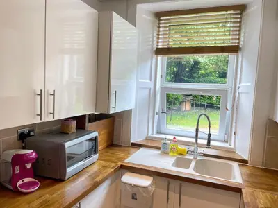 a kitchen with a sink and a microwave at Lovely two bedrooms in Edinburgh