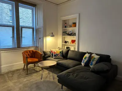 a living room with a couch and a table at Lovely two bedrooms in Edinburgh