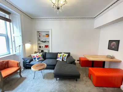 a living room with a couch and a table at Lovely two bedrooms in Edinburgh
