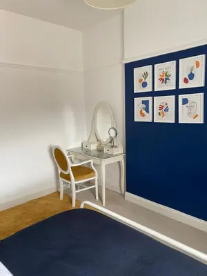 a room with a table and a mirror and a blue door at Caerlaverock Cottage in Prestwick