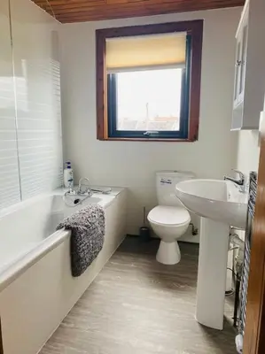 a bathroom with a sink and a toilet and a bath tub at Golfers lovers! Near all famous golf courses in Prestwick