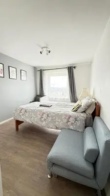 a bedroom with a bed and a couch and a window at Top Floor of the building, spectacular views! in Glasgow
