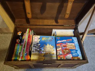 a wooden box filled with childrens books at 2 bed Lodge near Dunoon on the Shore Front in Dunoon