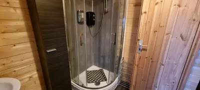 a shower with a black phone in a bathroom at 2 bed Lodge near Dunoon on the Shore Front in Dunoon