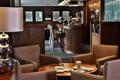 a restaurant with a table and chairs and a bar at Best Western Motherwell Centre Moorings Hotel in Motherwell