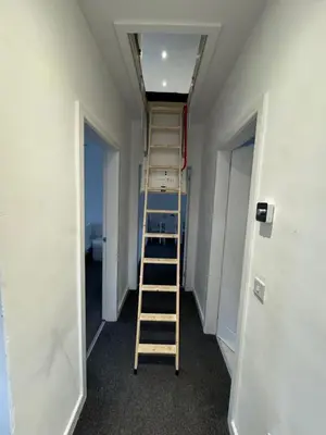 a room with a ladder in the middle of a room at Modern 2 bedroom House With Loft Conversion in Glasgow