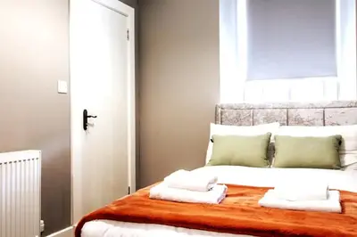 a bedroom with a bed with towels on it at Private Garden West End with Parking - Pass the Keys in Glasgow