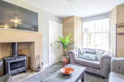 a living room with a couch and a fireplace at Private Garden West End with Parking - Pass the Keys in Glasgow