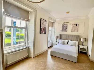 a bedroom with a white bed and a window at 9 Bedroom all Ensuite- Exclusive Use in Auchterarder