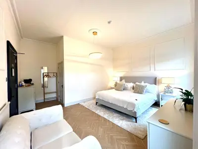 a white bedroom with a bed and a couch at 9 Bedroom all Ensuite- Exclusive Use in Auchterarder