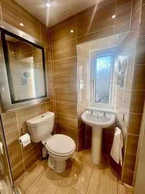 a bathroom with a toilet and a sink at 'Hamish' in ApartNest Auchterarder in Auchterarder