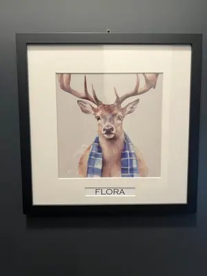 a picture of a deer in a frame on a wall at 'Flora' in ApartNest Auchterarder in Auchterarder