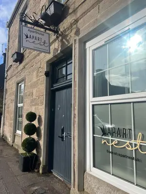 a door to a store with a sign on it at 'Flora' in ApartNest Auchterarder in Auchterarder