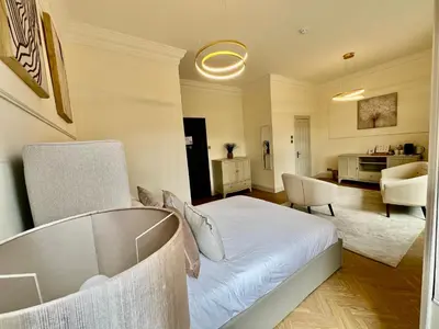 a bedroom with a bed and a living room at 'Flora' in ApartNest Auchterarder in Auchterarder