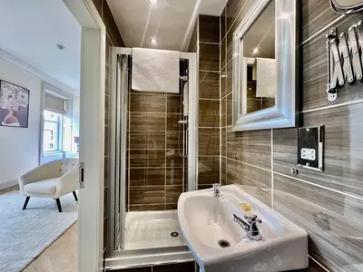 a bathroom with a sink and a shower at 'Flora' in ApartNest Auchterarder in Auchterarder