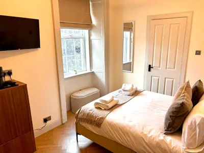 a bedroom with a bed with two towels on it at 'Mac' in ApartNest Auchterarder in Auchterarder