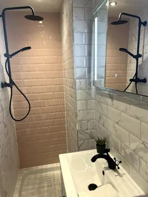 a white bathroom with a sink and a shower at 'Mac' in ApartNest Auchterarder in Auchterarder