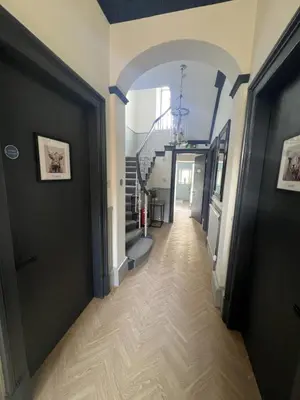 a hallway with an archway and stairs in a house at 'Blair' in ApartNest Auchterarder in Auchterarder