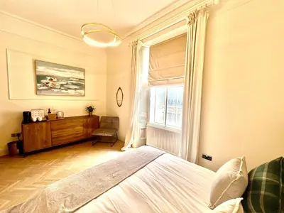 a bedroom with a large bed and a window at 'Gordon' in ApartNest Auchterarder in Auchterarder