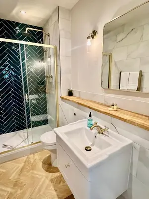 a white bathroom with a sink and a shower at 'Gordon' in ApartNest Auchterarder in Auchterarder
