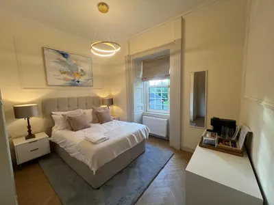 a bedroom with a white bed and a window at 'Maisie' in ApartNest Auchterarder in Auchterarder