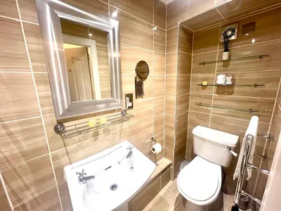 a bathroom with a toilet and a sink and a mirror at 'Maisie' in ApartNest Auchterarder in Auchterarder
