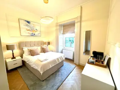 a bedroom with a white bed and a window at 'Maisie' in ApartNest Auchterarder in Auchterarder