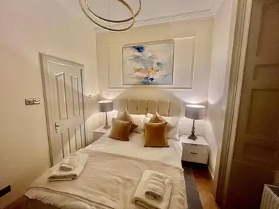 a bedroom with a bed with two towels on it at 'Maisie' in ApartNest Auchterarder in Auchterarder
