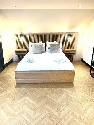 a bedroom with a large bed with white sheets and pillows at 'Clyde' in ApartNest Auchterarder in Auchterarder
