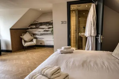 a bedroom with a bed with towels on it at 'Clyde' in ApartNest Auchterarder in Auchterarder