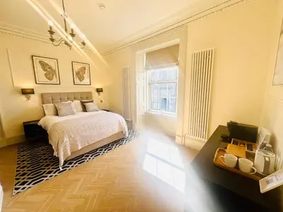 a bedroom with a bed and a large window at 'Douglas' in ApartNest Auchterarder in Auchterarder