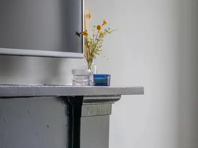 a table with a vase of flowers on it at West End Cosy Pop of Colour - Pass the Keys in Glasgow