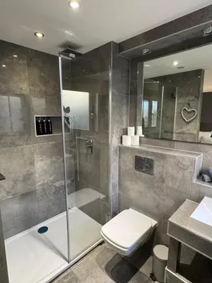 a bathroom with a shower and a toilet and a sink at KM Granton Apartment in Edinburgh