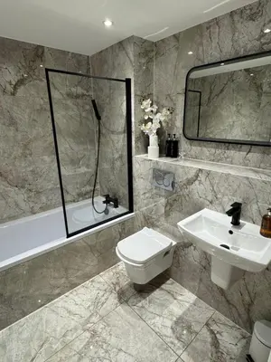 a bathroom with a sink and a toilet and a shower at KM Granton Apartment in Edinburgh