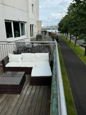 a couch sitting on top of a deck at KM Granton Apartment in Edinburgh