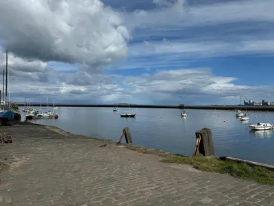 a large body of water with boats in it at KM Granton Apartment in Edinburgh