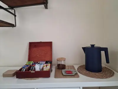 a table with a coffee maker and a box on it at Yuriko in Saint Davids