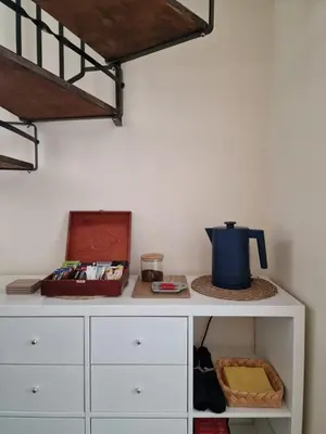 a white cabinet with a blue pot on top of it at Yuriko in Saint Davids