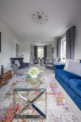 a living room with a blue couch and a table at Quiet 2 bedroom gem in Stirling in Bridge of Allan