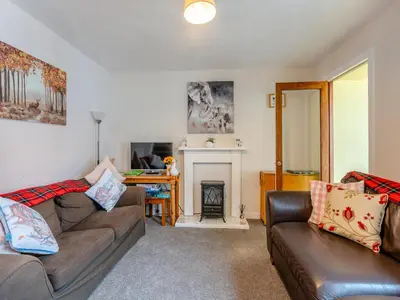 a living room with two couches and a fireplace at Carraig Dhubh North - Uk47125 in Whiting Bay