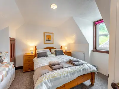 a bedroom with a bed with two pillows on it at Carraig Dhubh North - Uk47125 in Whiting Bay