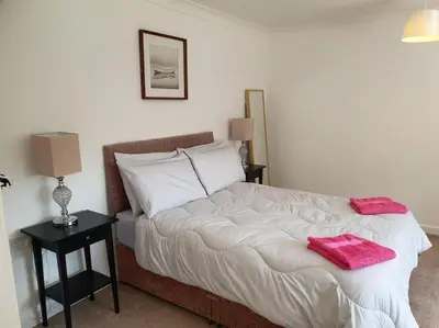 a bedroom with a bed with two towels on it at THE ELFIN- Lovely 1 Bedroom - Free Parking in Bridge of Allan