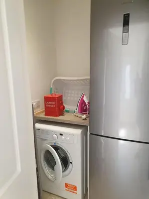 a kitchen with a washing machine and a refrigerator at THE ELFIN- Lovely 1 Bedroom - Free Parking in Bridge of Allan