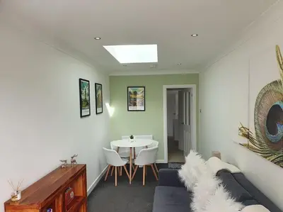 a living room with a couch and a table at THE ELFIN- Lovely 1 Bedroom - Free Parking in Bridge of Allan