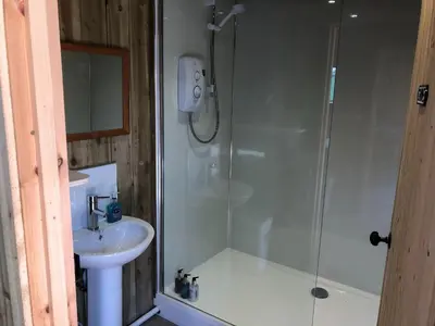 a bathroom with a shower and a sink at The Bothy and Wagon at Pitmeadow Farm in Perth
