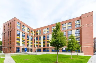 a brick building with trees in front of it at Student Only Merchant Studios in Glasgow in Glasgow