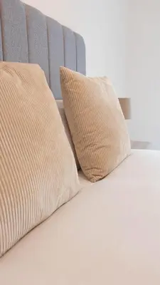 a bed with two pillows on top of it at 3 BDR House At Caledonia Luxe Stays Short Lets & Serviced Accommodation Tillicoultry in Tillicoultry