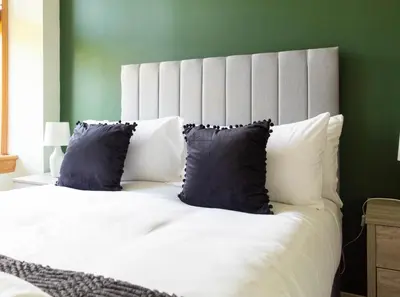 a bedroom with a large white bed with blue pillows at 1 BDR Apt At Caledonia Luxe Stays Short Lets & Serviced Accommodation Paisley in Paisley