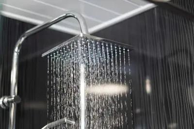 a shower in a bathroom with a shower head at Hardgate House Hotel in Clydebank