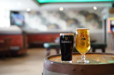 a glass of beer sitting on top of a barrel at Hardgate House Hotel in Clydebank